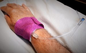 Chemotherapy infusion tube taped to wrist