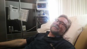 Lying back in the chair for a chemotherapy infusion.
